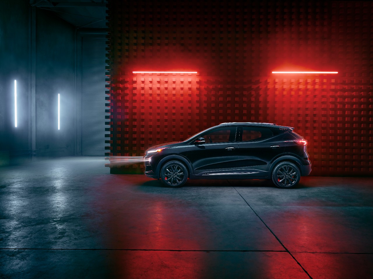 Side view of black Chevrolet Bolt EUV at night.