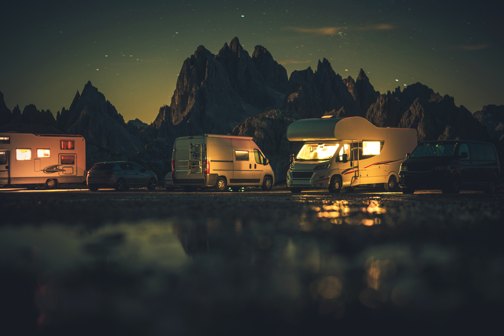 3 RVs lakeside at night