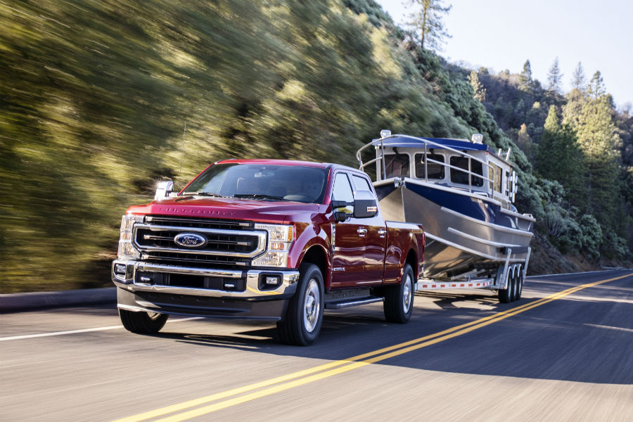 front view of a red 2020 Ford Super Duty towing a boat