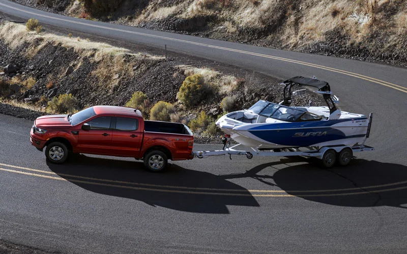 image of red ford ranger towing boat