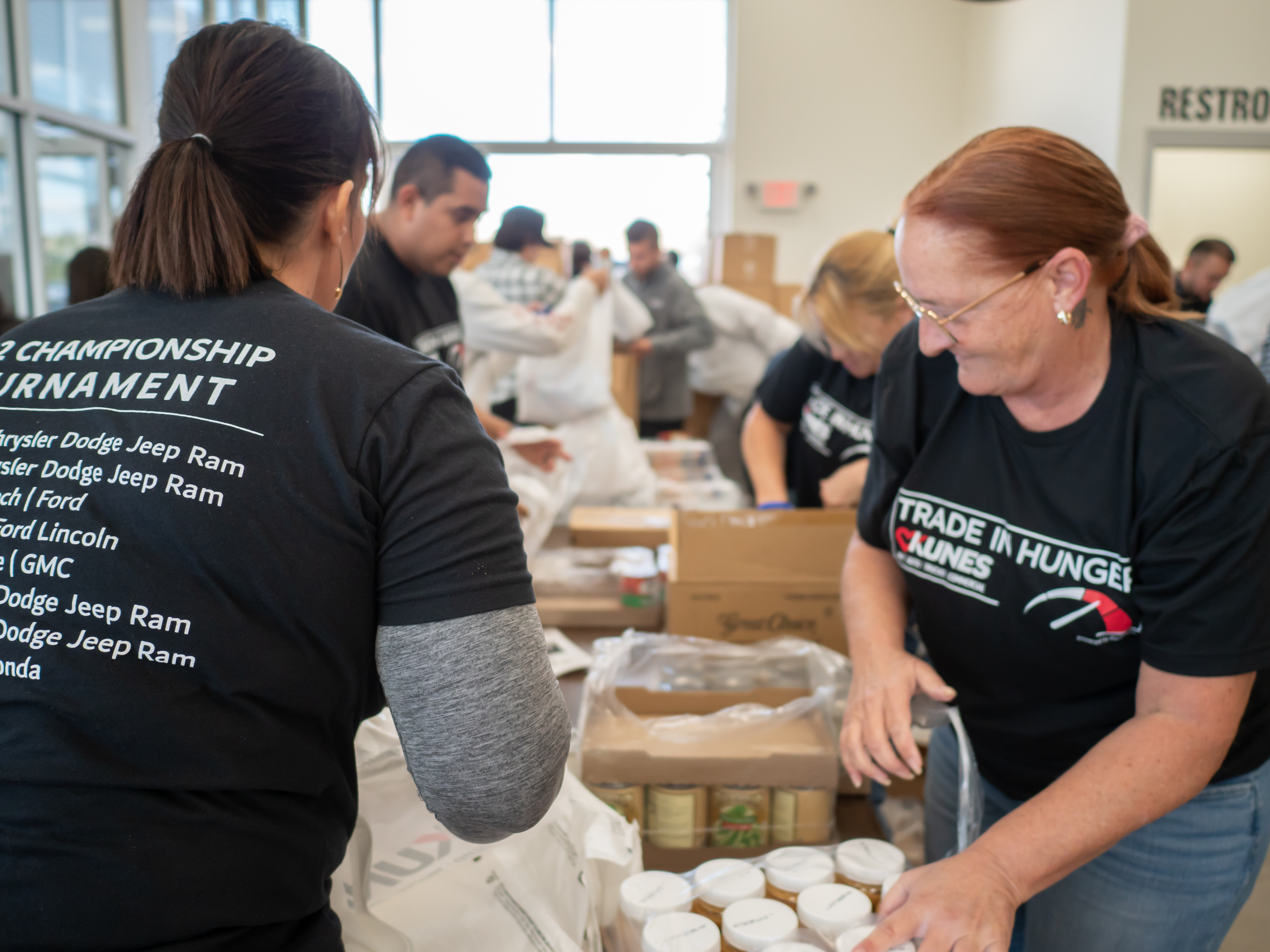 Volunteers helping package food.