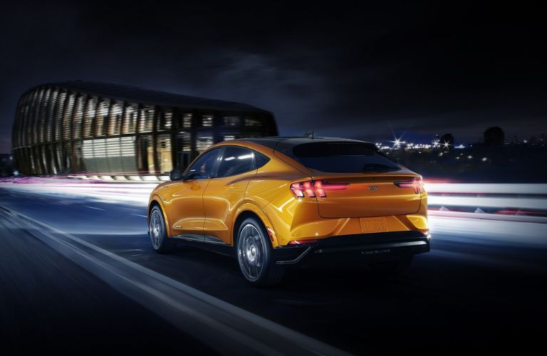 Yellow 2023 Ford Mustang Mach-E Rear Exterior on Highway at Night