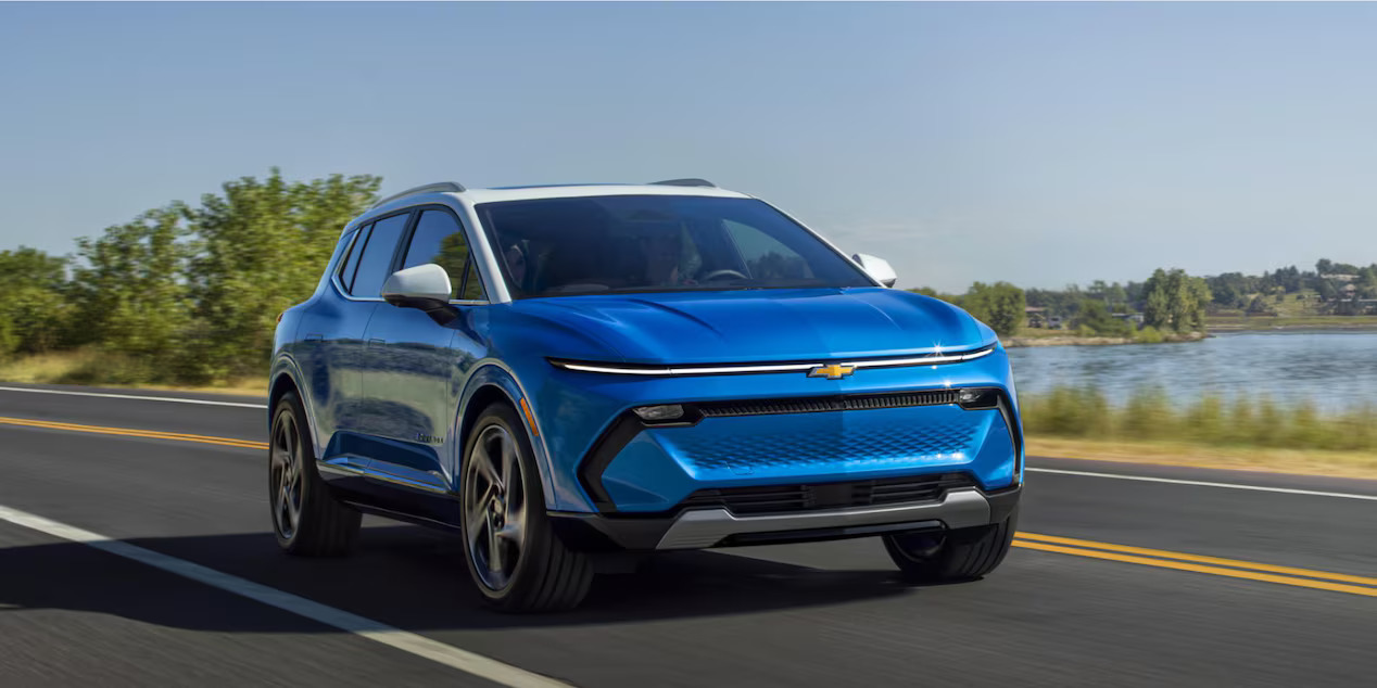 A blue Chevrolet Equinox EV driving on the road. 