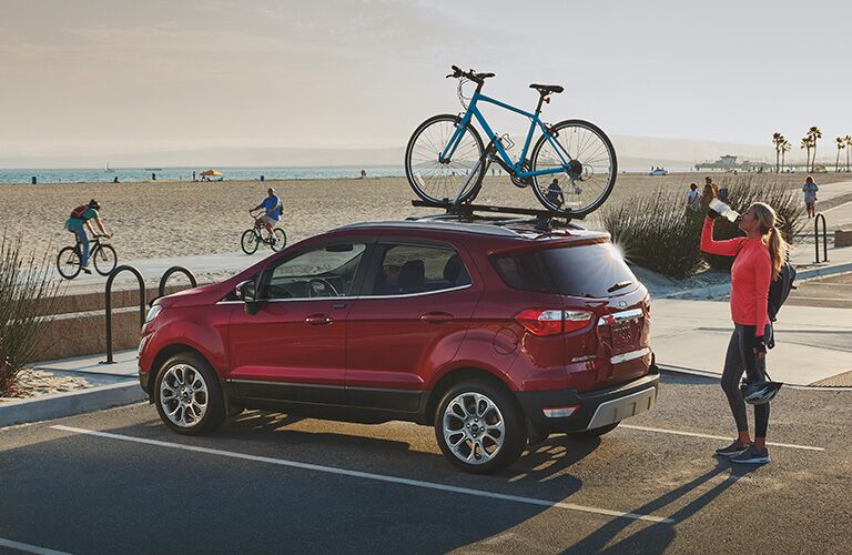 side view of a red 2021 Ford EcoSport with a bike on its roof rack
