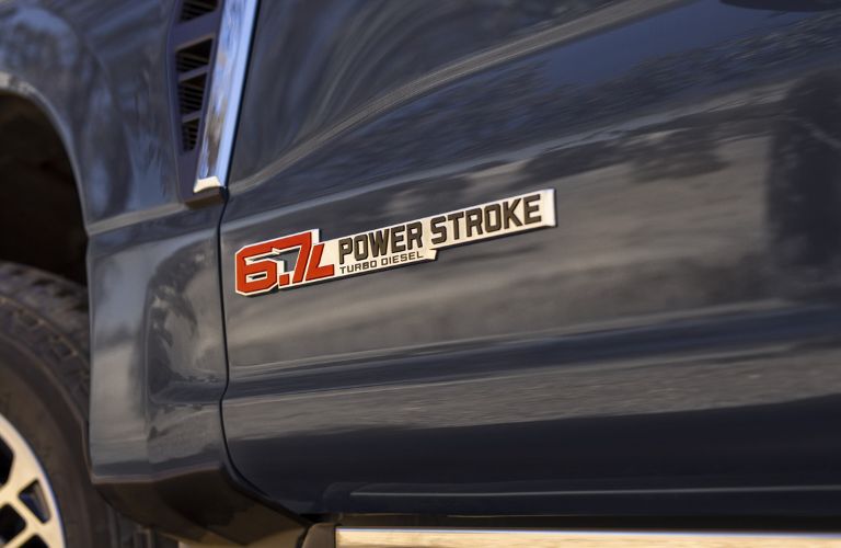 Close Up of Red 6.7-Liter Power Stroke Badge on Blue 2024 Ford Super Duty