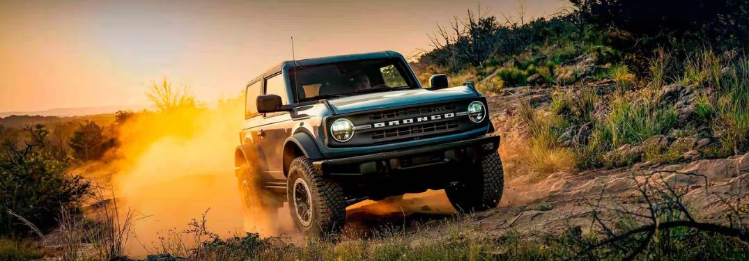 Blue 2024 Ford Bronco on a Desert Trail at Sunset