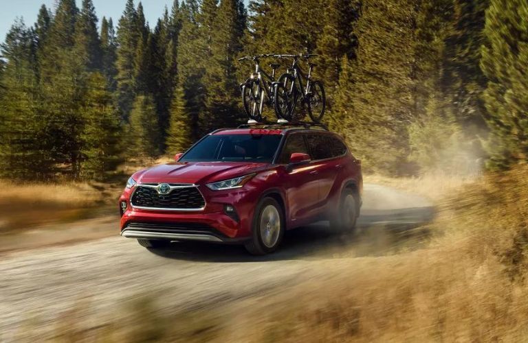 Red 2022 Toyota Highlander on a Dirt Road with a Bike Rack