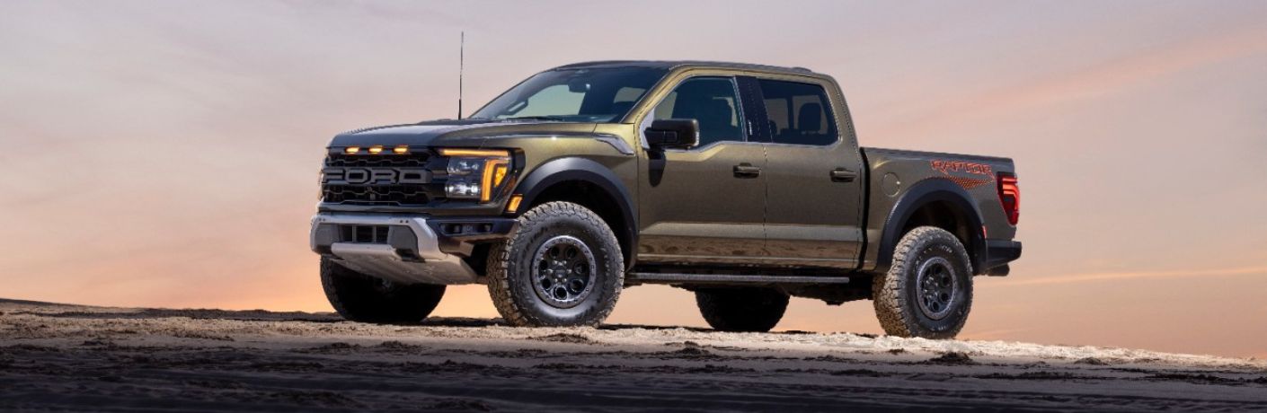 Green 2024 Ford F-150 Raptor Side Exterior in a Desert at Dawn
