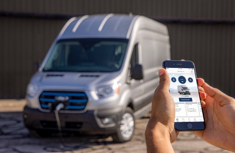 person using cell phone to check on their 2022 Ford E-Transit