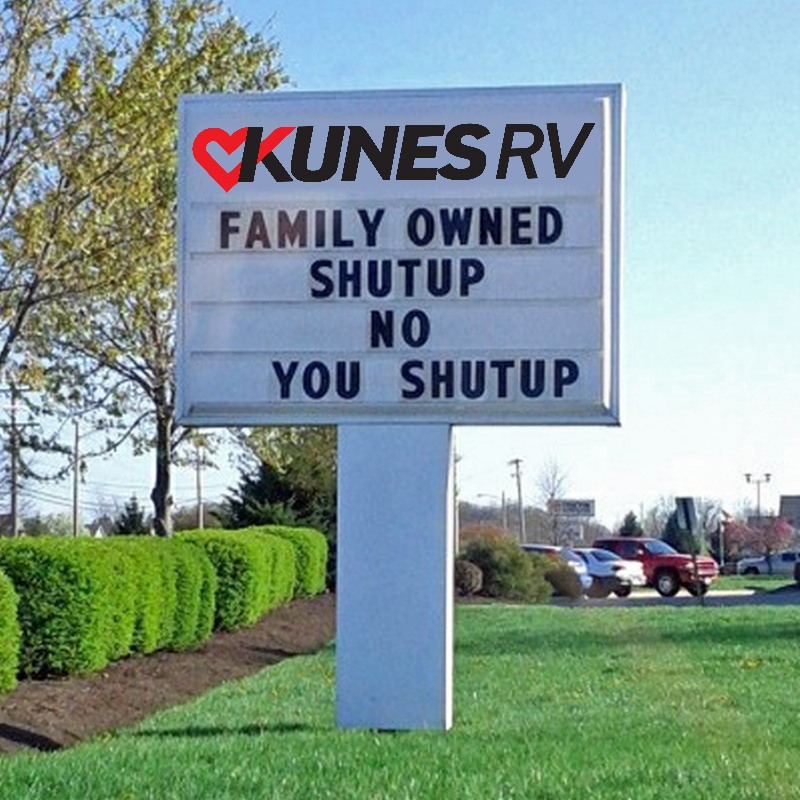 Kunes RV sign that says "Family owned; shutup; no; you shutup"
