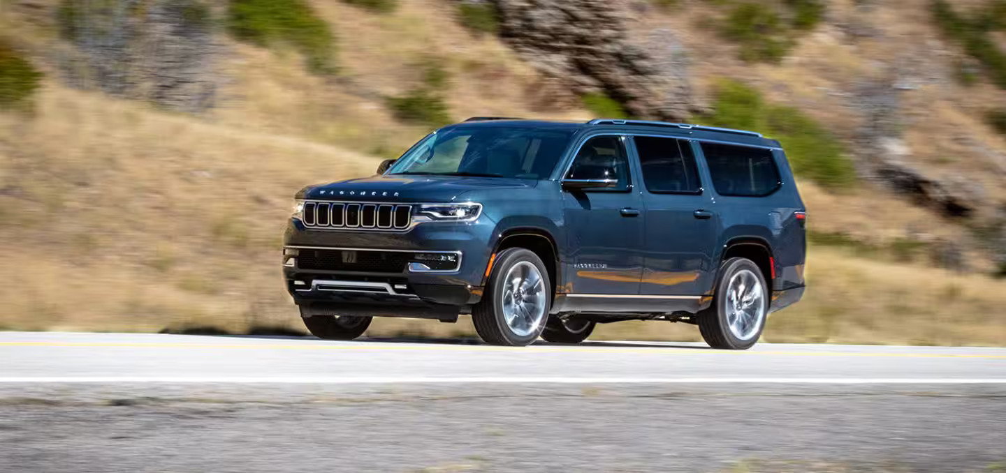 The 2024 Jeep Wagoneer driving on the road.