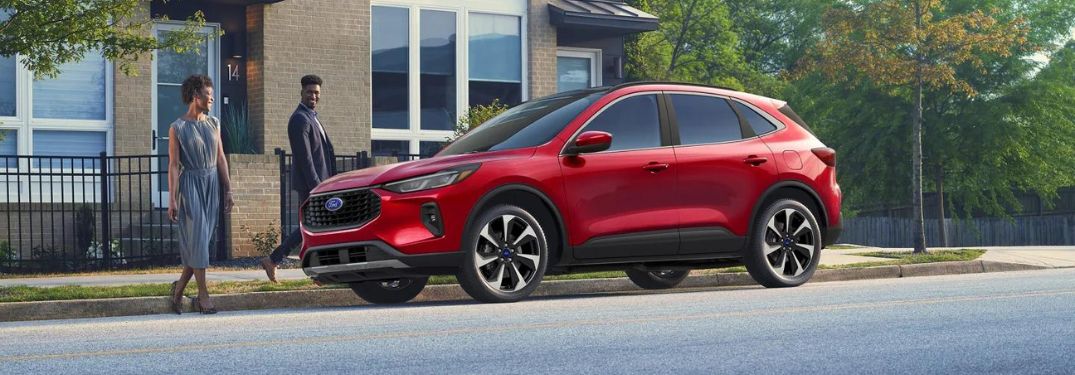 Couple with Red 2025 Ford Escape on the Side of the Road