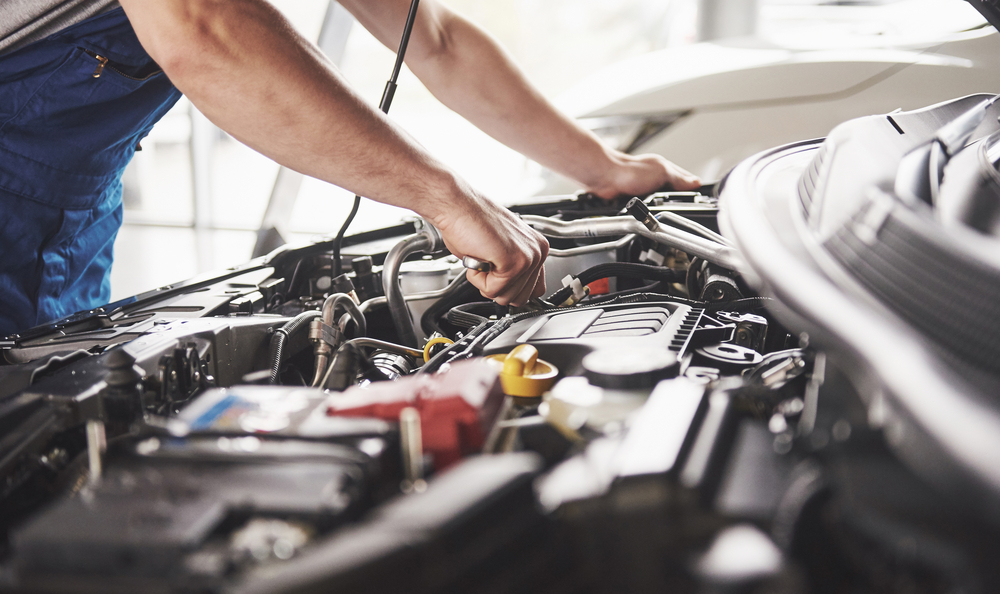 mechanic hands working on a vehicle's engine