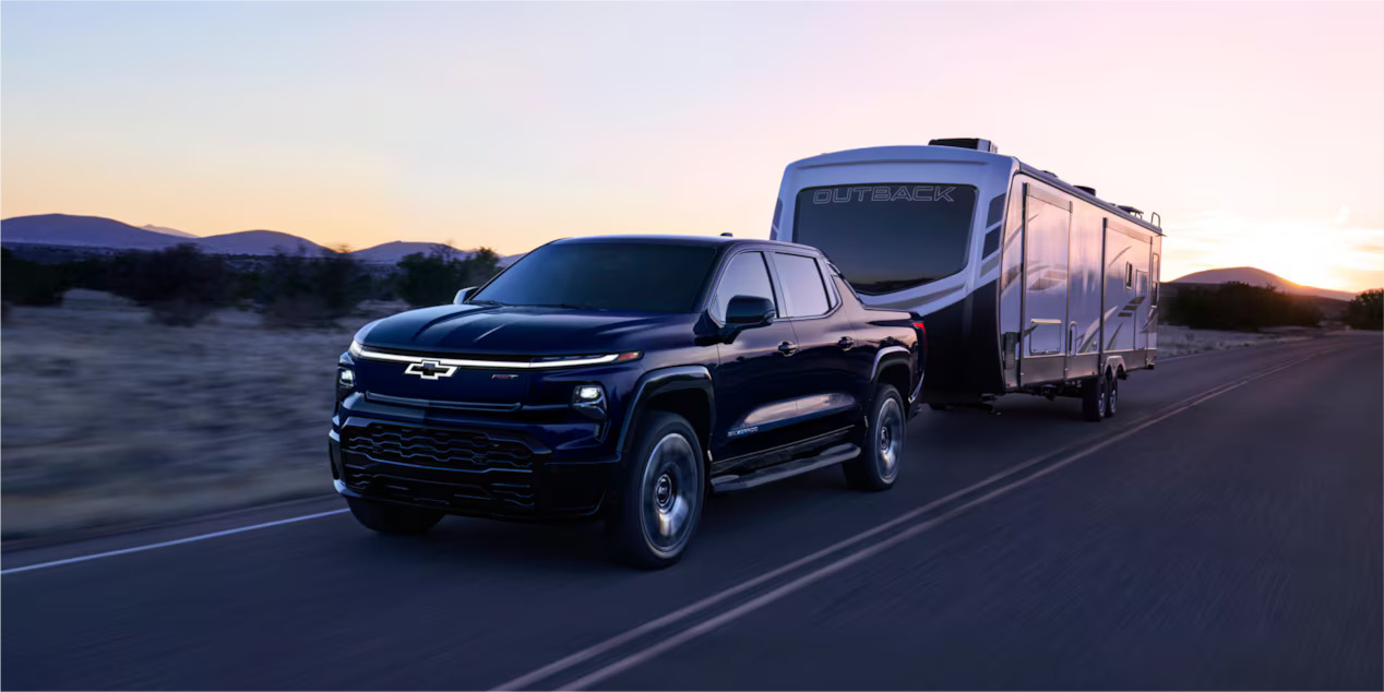 A silverado ev pulling a mobile home.