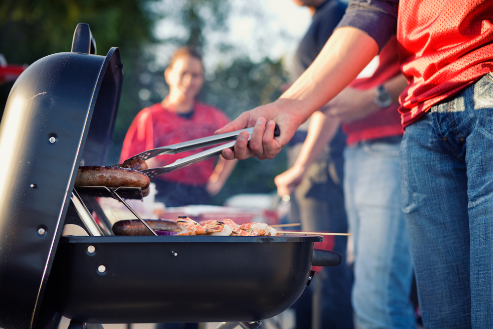 griller fliips food at a tailgate party