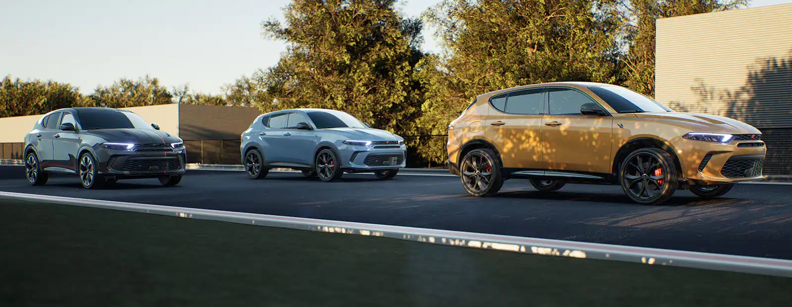 left to right: black dodge hornet, light blue dodge hornet, and gold dodge hornet driving down the road