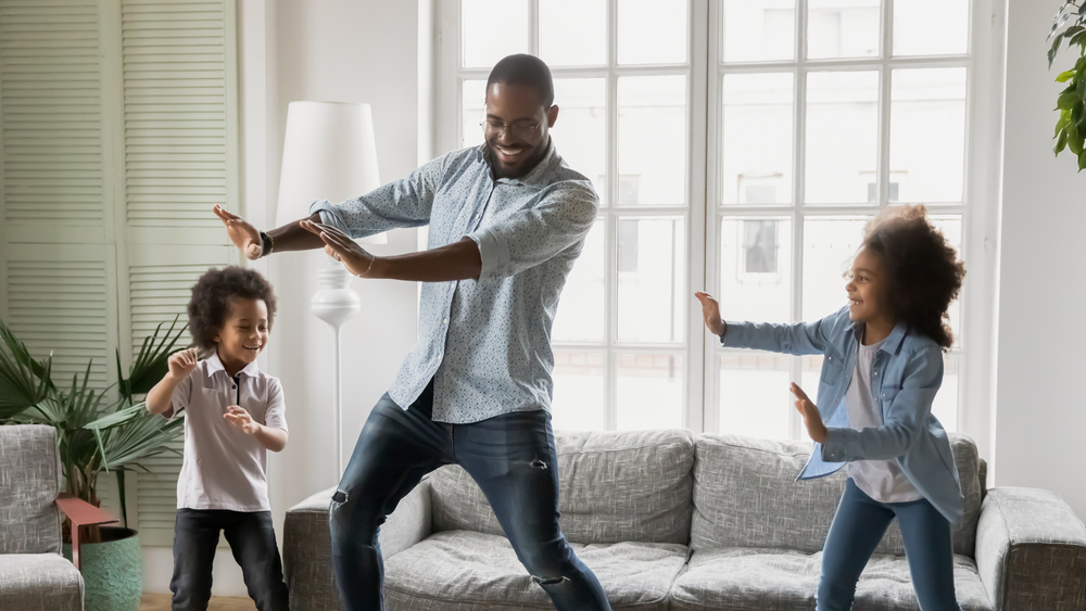 dad dancing with his kids in livingroom
