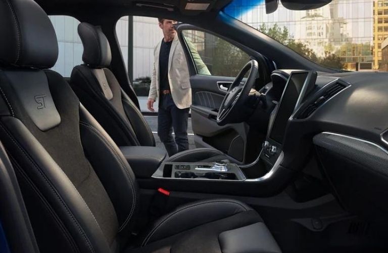 A man getting in the driver's seat in the 2022 Ford Edge. 