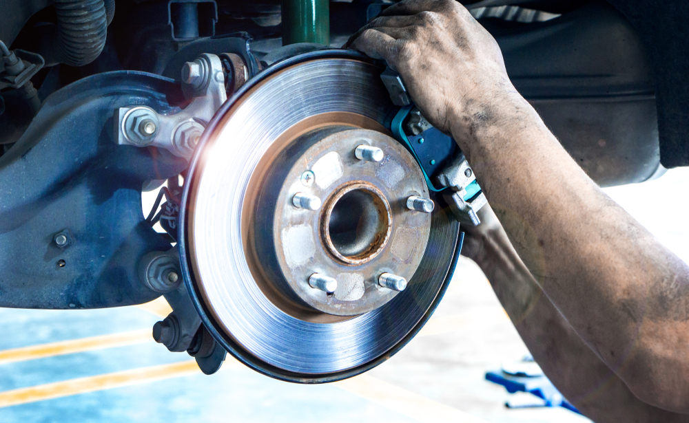 brake rotor being adjusted by mechanic