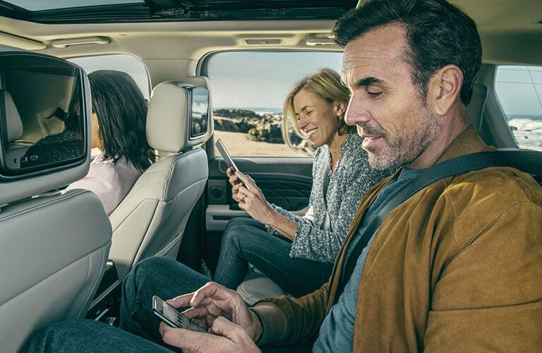 adults sitting in the back row of a 2021 Ford Expedition