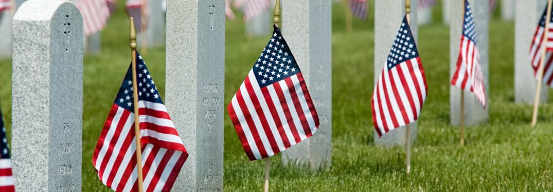 Close Up of Flags and Headstones on Memorial Day