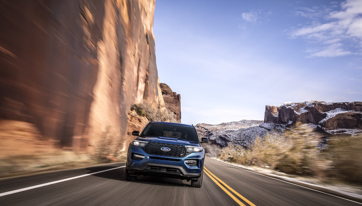 Ford SUV driving against snowy mountain terrain