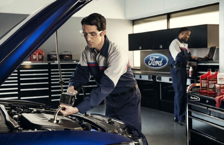 Ford tech working under the hood