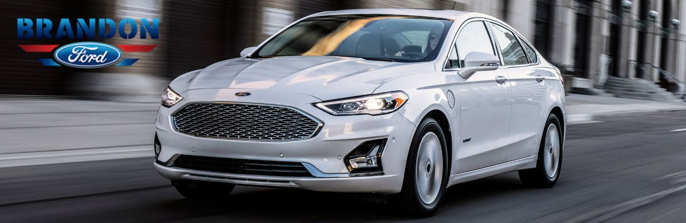 White 2020 Ford Fusion Front Exterior on a City Street and Brandon Ford Logo