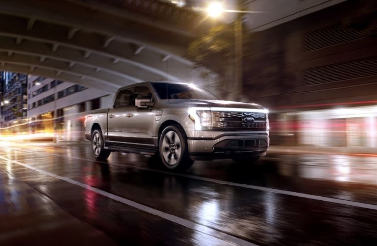 Silver 2022 Ford F-150 Lighting Front Exterior on a City Street at Night