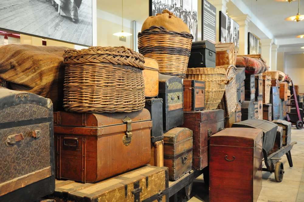 early 1800's luggage stacked along a wall in a museum