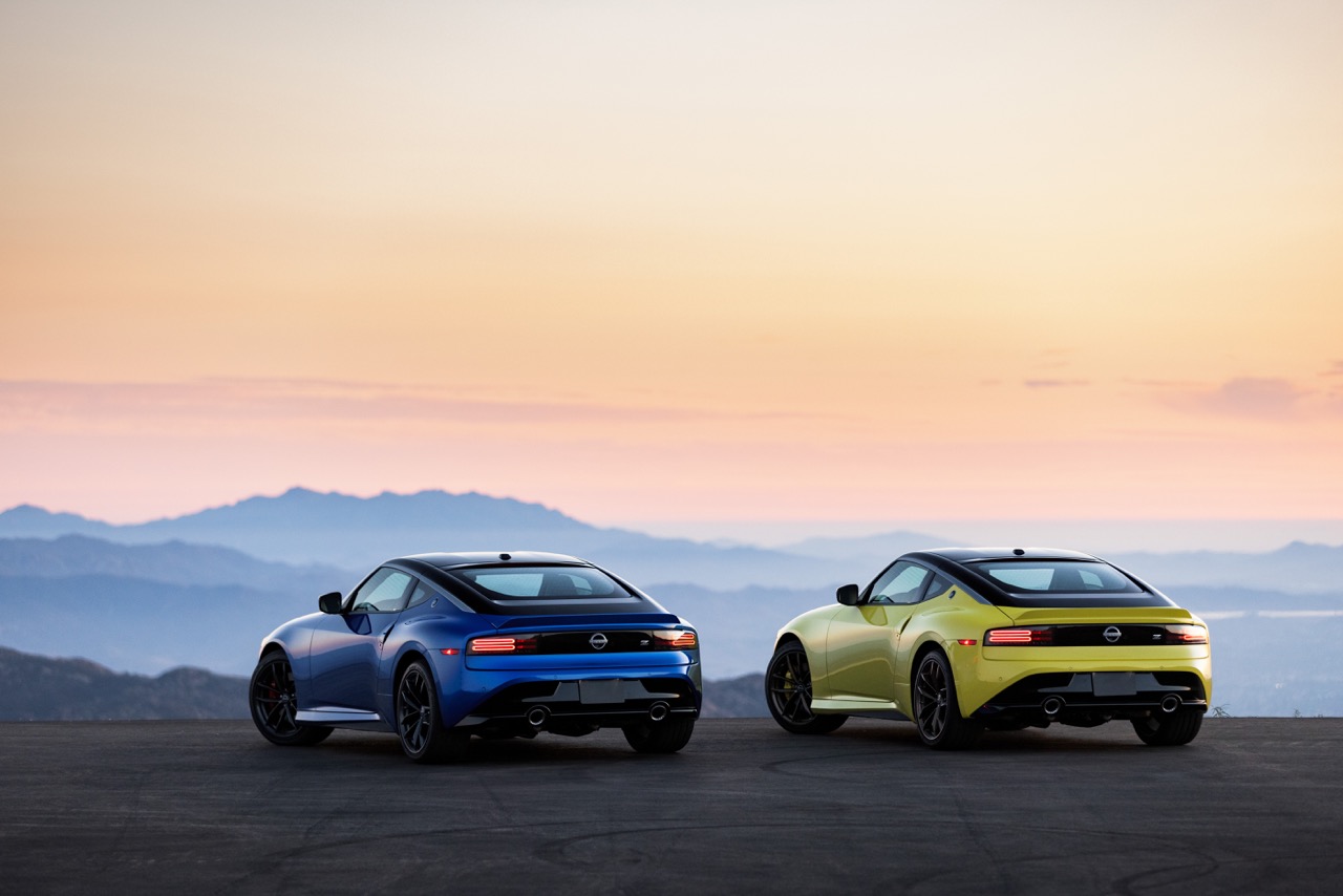 Two Nissan Z vehicles sitting on a mountain