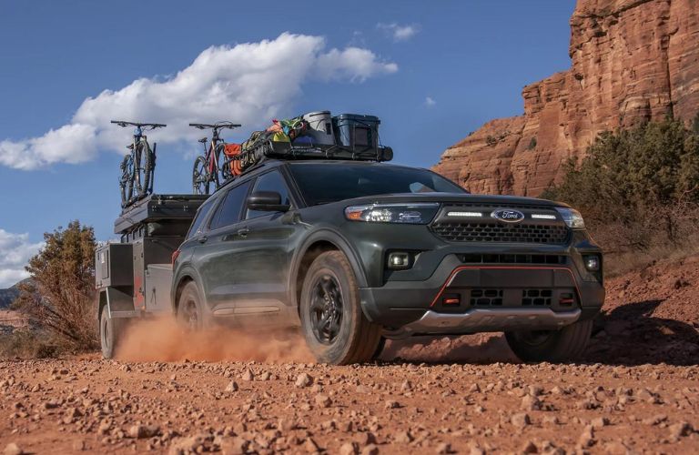 Green 2023 Ford Explorer Timberline Towing on a Trail