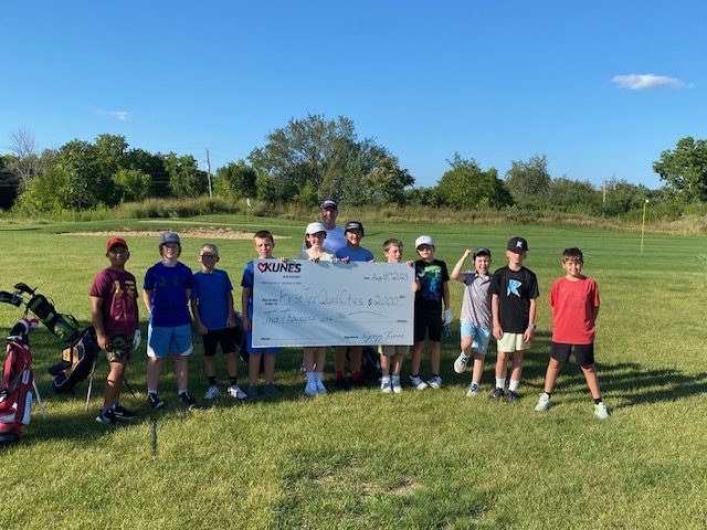 Kids from First Tee Quad Cities hold a $2,000 check that Kunes Nissan of Davenport donated