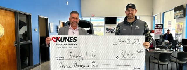 General manager of Kunes Honda of Quincy awarding member of Young Life with three-thousand dollar check