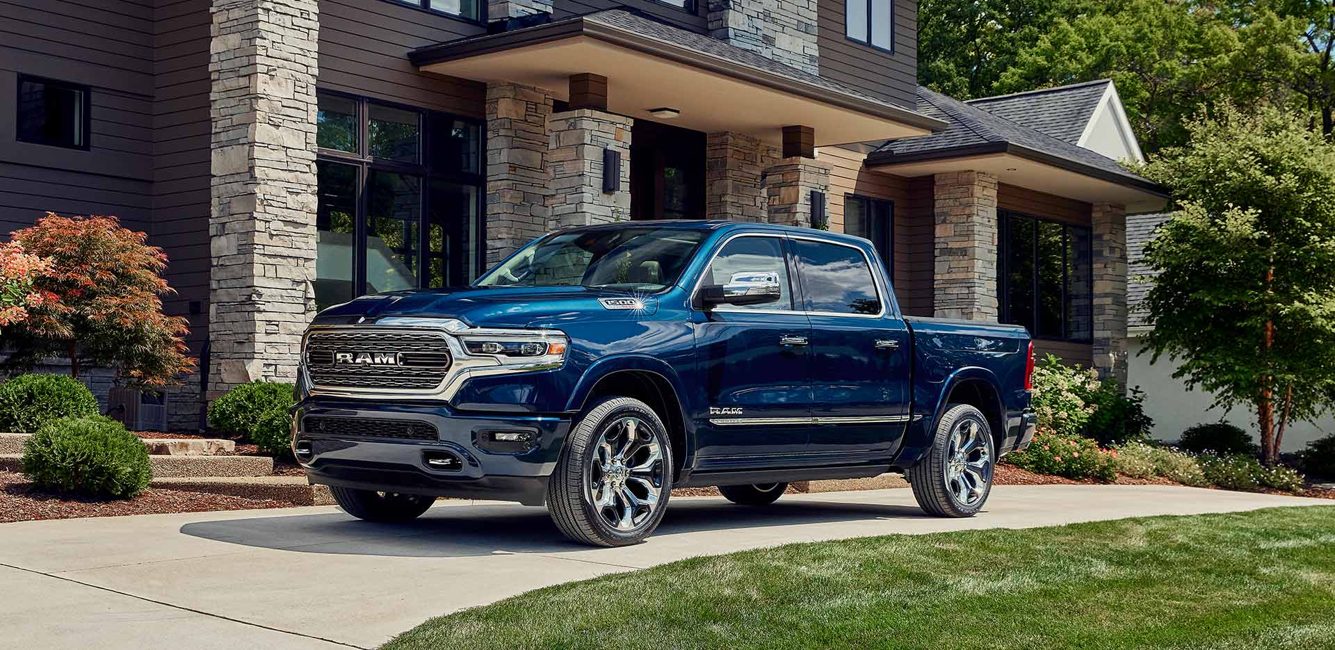 Blue 2023 RAM 1500 pictured in front of a house