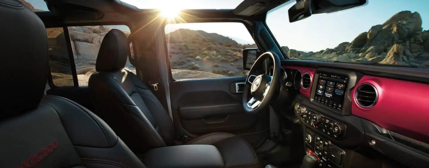 The red and black interor is shown in a  2022 Jeep Gladiator.