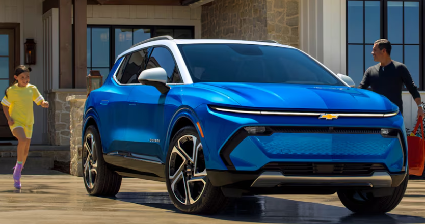 Father and daughter entering their 2024 Chevrolet Equinox EV with blue paint.