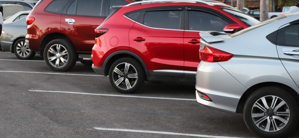 row of SUVs and other vehicles parked in a parking lot