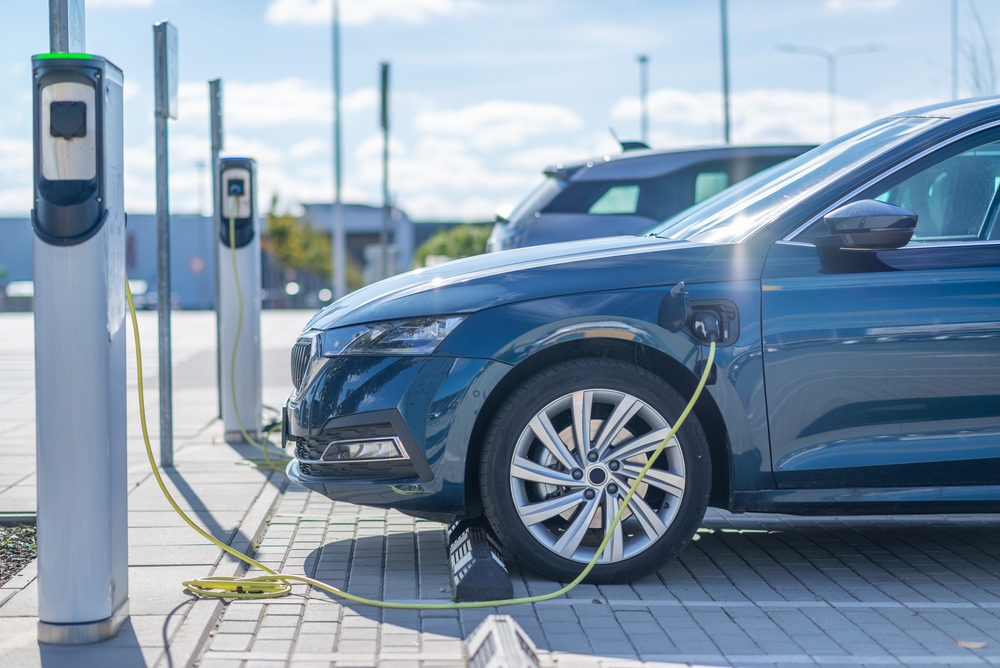 Electric vehicle (EV) plugged into a charging station