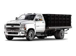 A white Chevrolet 4500 base on a front driver side view in a factory with concrete floors and a half and half white a grey wall