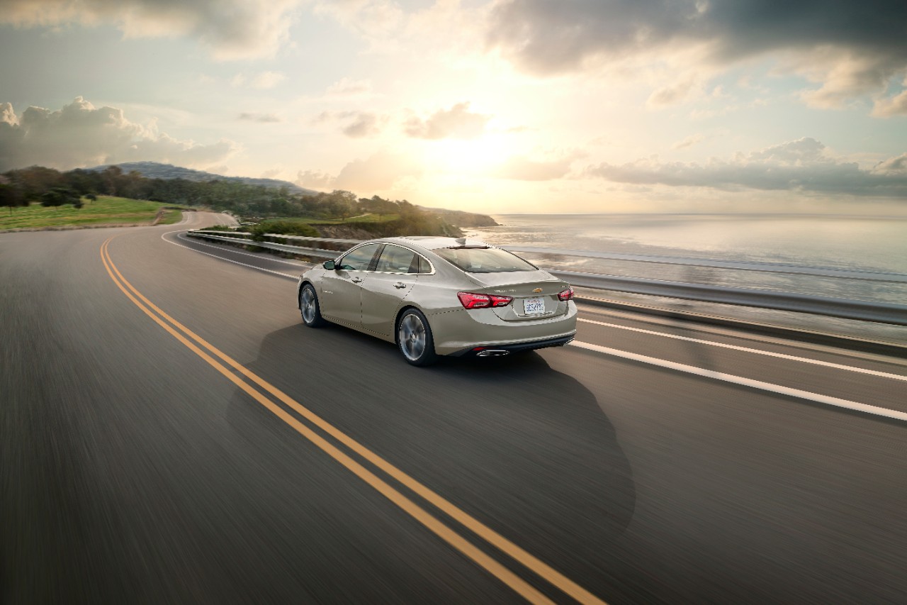 Rear 3/4 view of the 2024 Chevrolet Malibu Premier 1LZ in Mineral Gray Metallic.