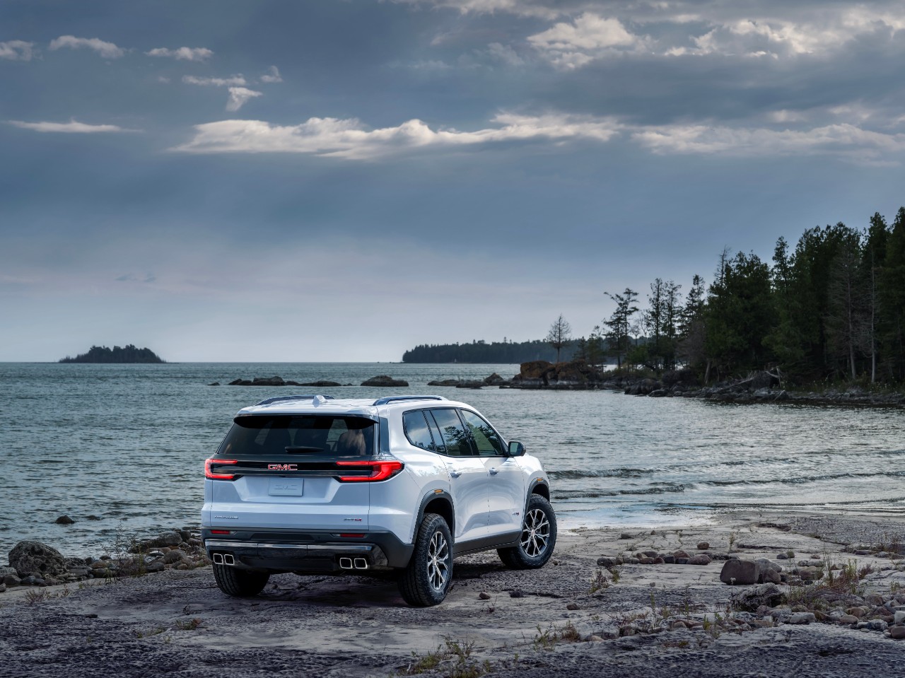 Back of GMC Acadia looking out over overcast lake. 