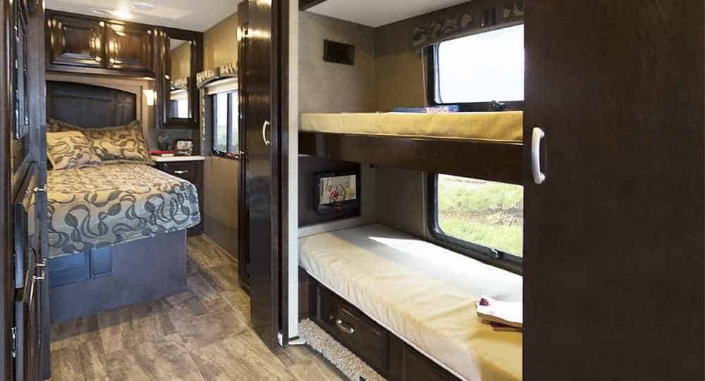 A bunkhouse camper with bunk beds and travel trailer