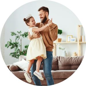 Father Holding Daughter Dressed as Princess and Dancing in the Living Room