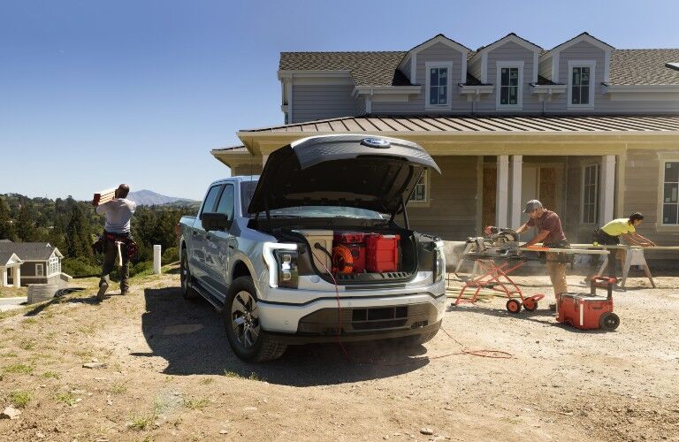 Construction working on house out of 2022 Ford F-150 Lightning