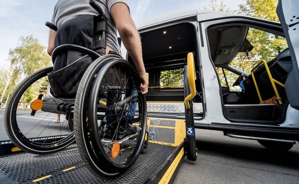 man in wheelchair on ramp to get into his mobility van