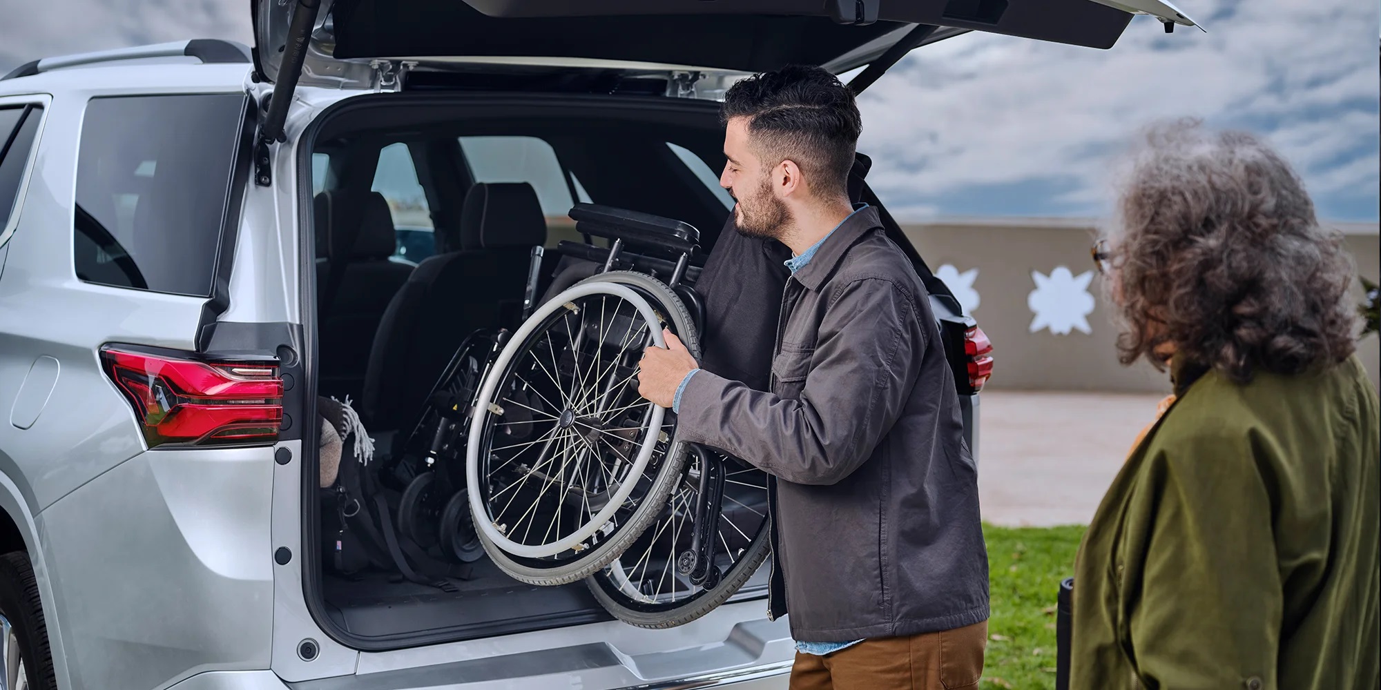 Man putting wheelchair into Traverse trunk