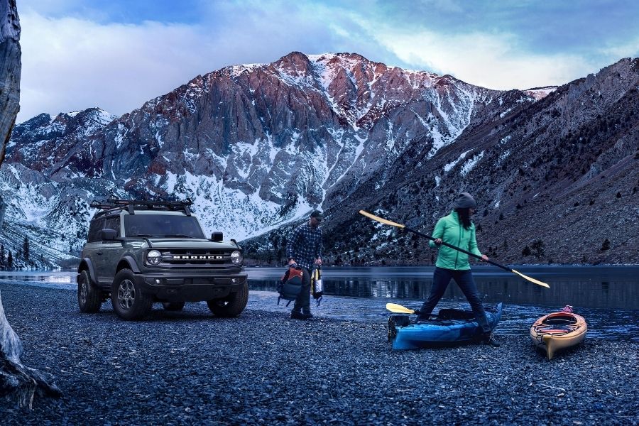 2021 Ford Bronco Front View Parked near a river with a snow-clad mountain in the background