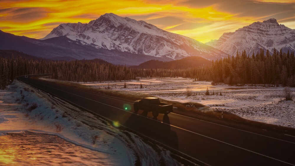 Pickup on Road and mountains winter time photo.