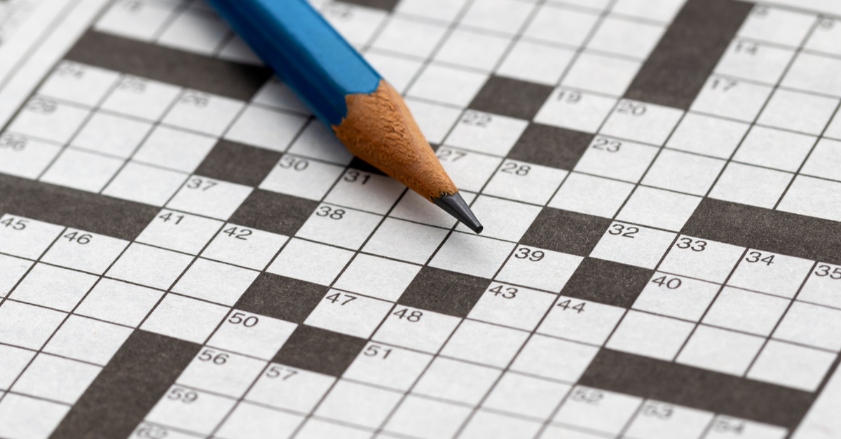 a lead pencil rests on a crossword puzzle